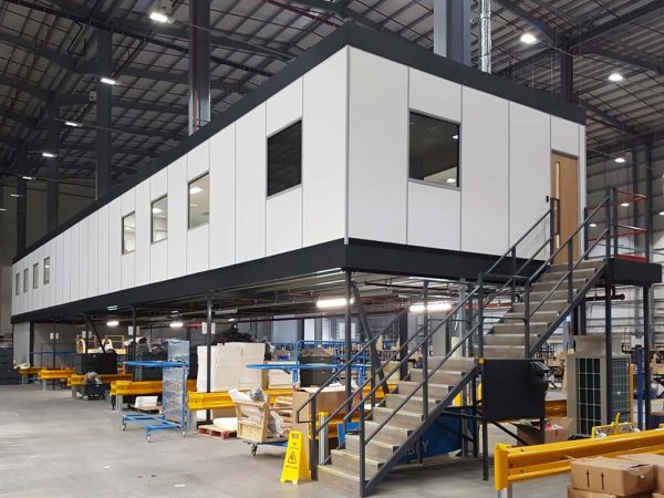 Mezzanine office built into industrial warehouse. Mezzanine inspiration for warehouse buildings.