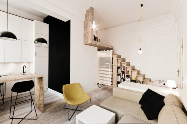 Mezzanine level for small apartment. Mezzanine Inspiration for tiny homes. Shows how mezzanine level does not take away from the design or space of the ground level while maximising space in small home. Bookcase doubles as stairs to access mezzanine.