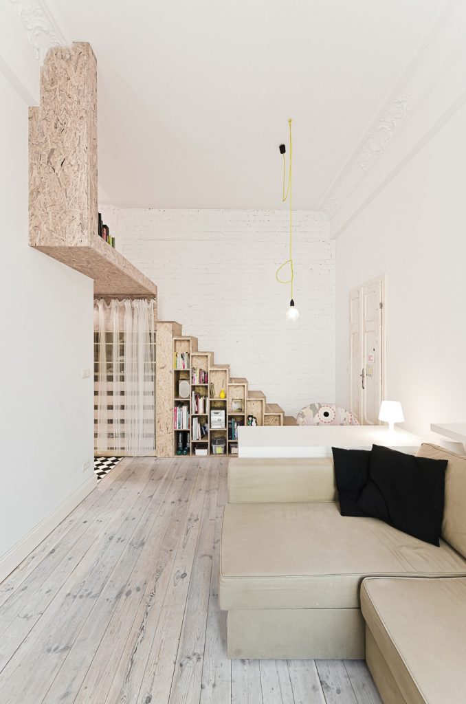 Shows mezzanine access from the view of the living room. From this angle, the mezzanine stairs just looks like a stylish bookcase and does not detract from the ground floor space. Space saving mezzanine inspiration.