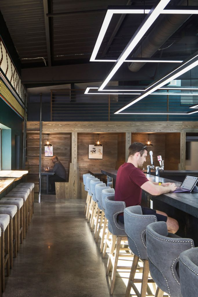 Inspiration for space beneath mezzanine. Pictured, private working booths built below mezzanine. Shows how mezzanines can maximise working space and break up a large room into smaller, more private sections.