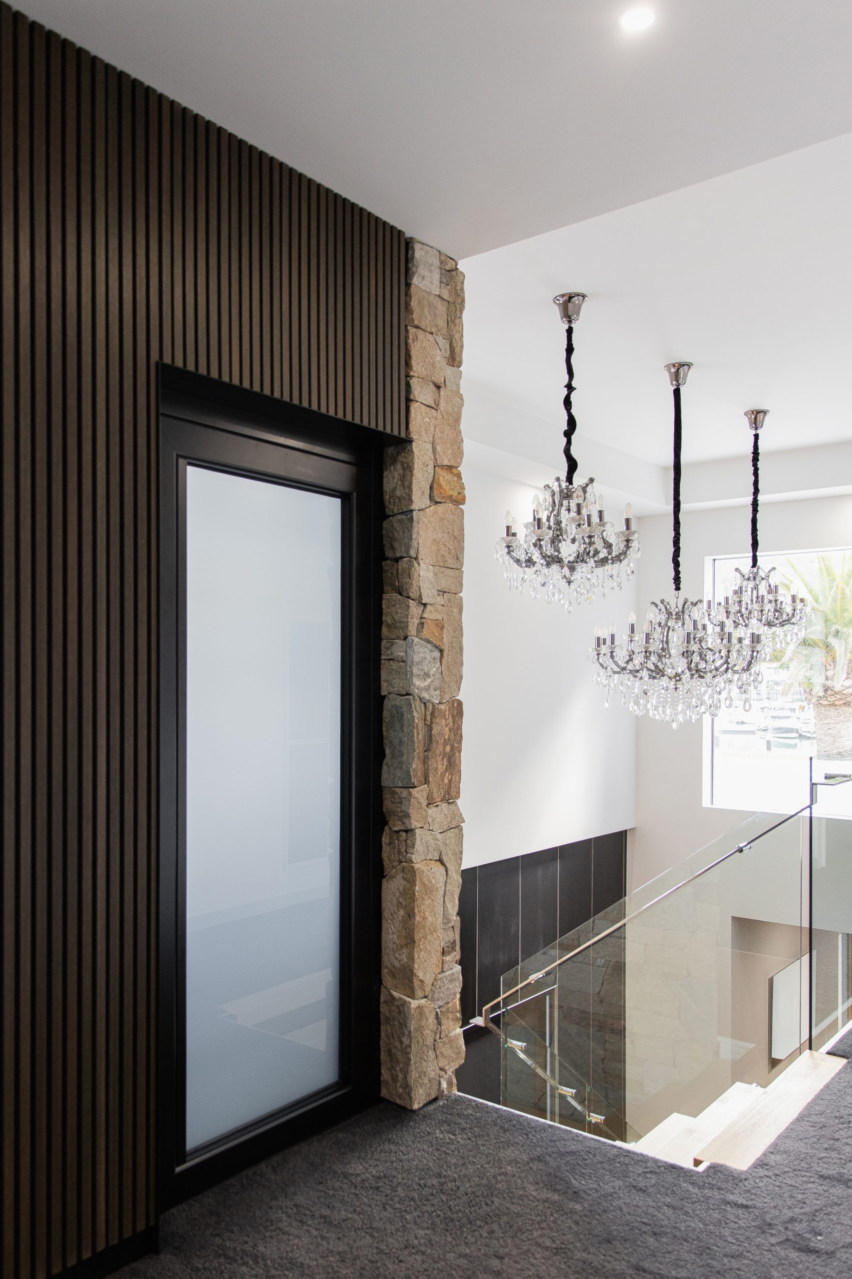 Residential sovereign home lift with a custom stone feature wall