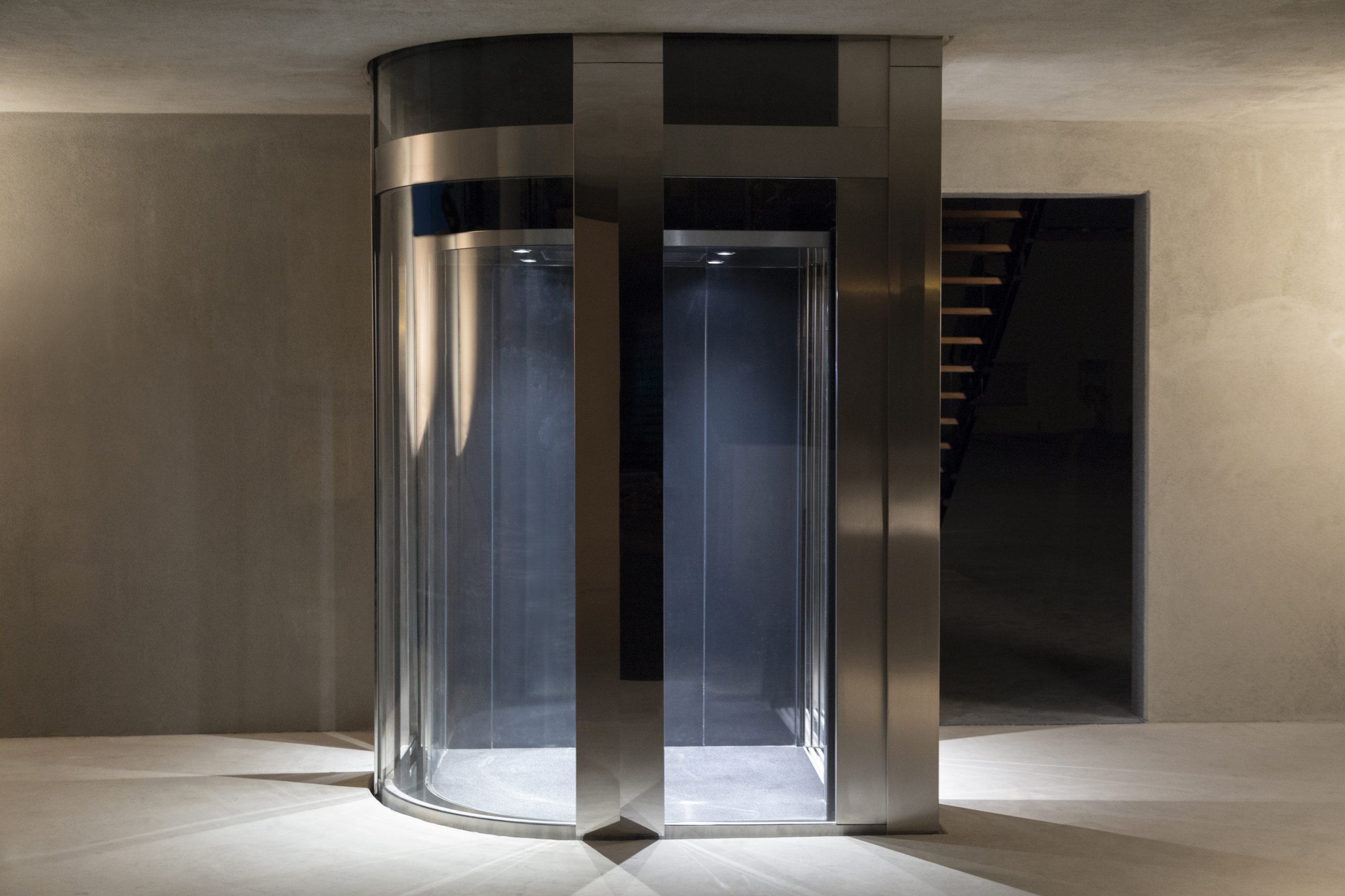 a stylish modern commercial elevator in the underground car park level.