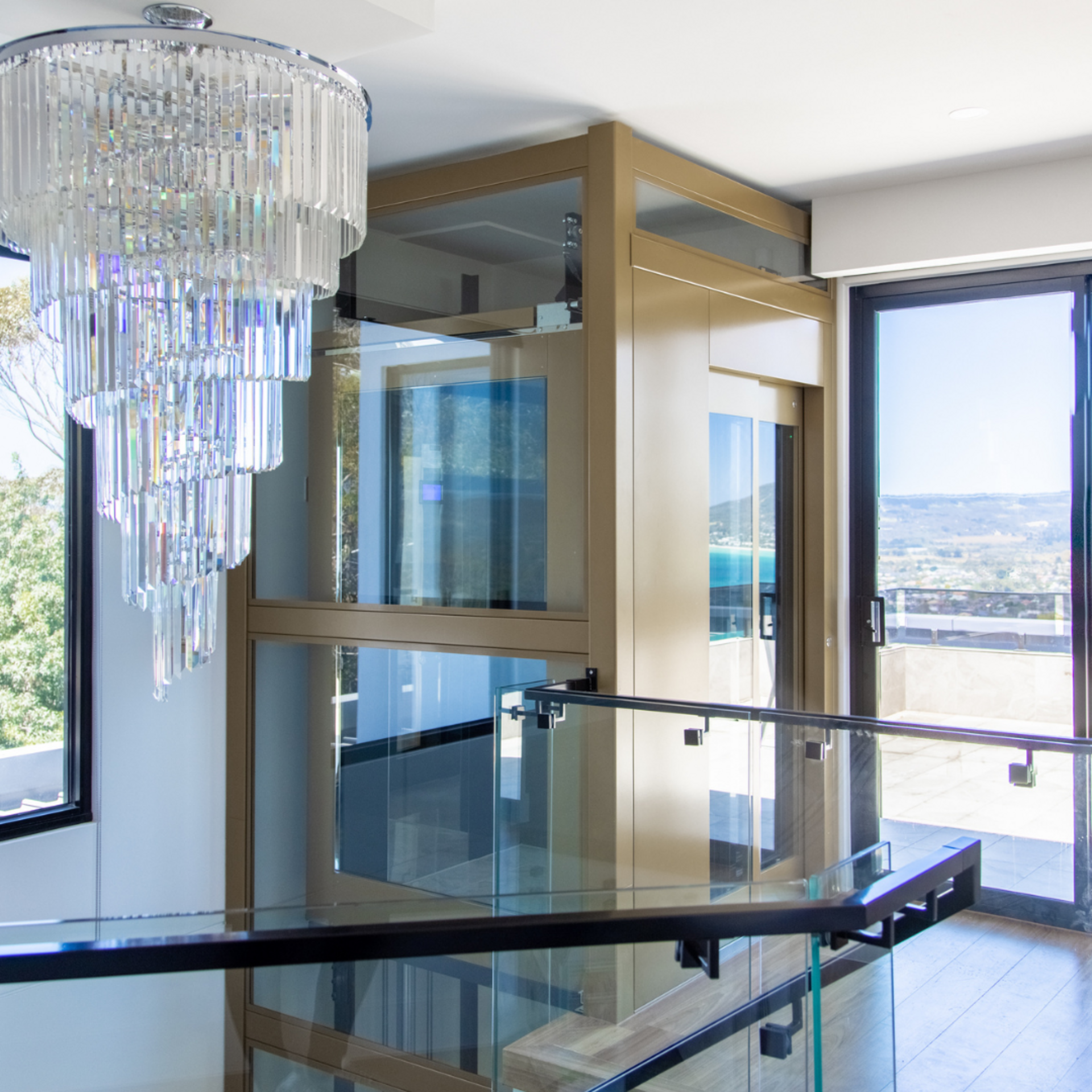 home elevator behind stunning chandelier