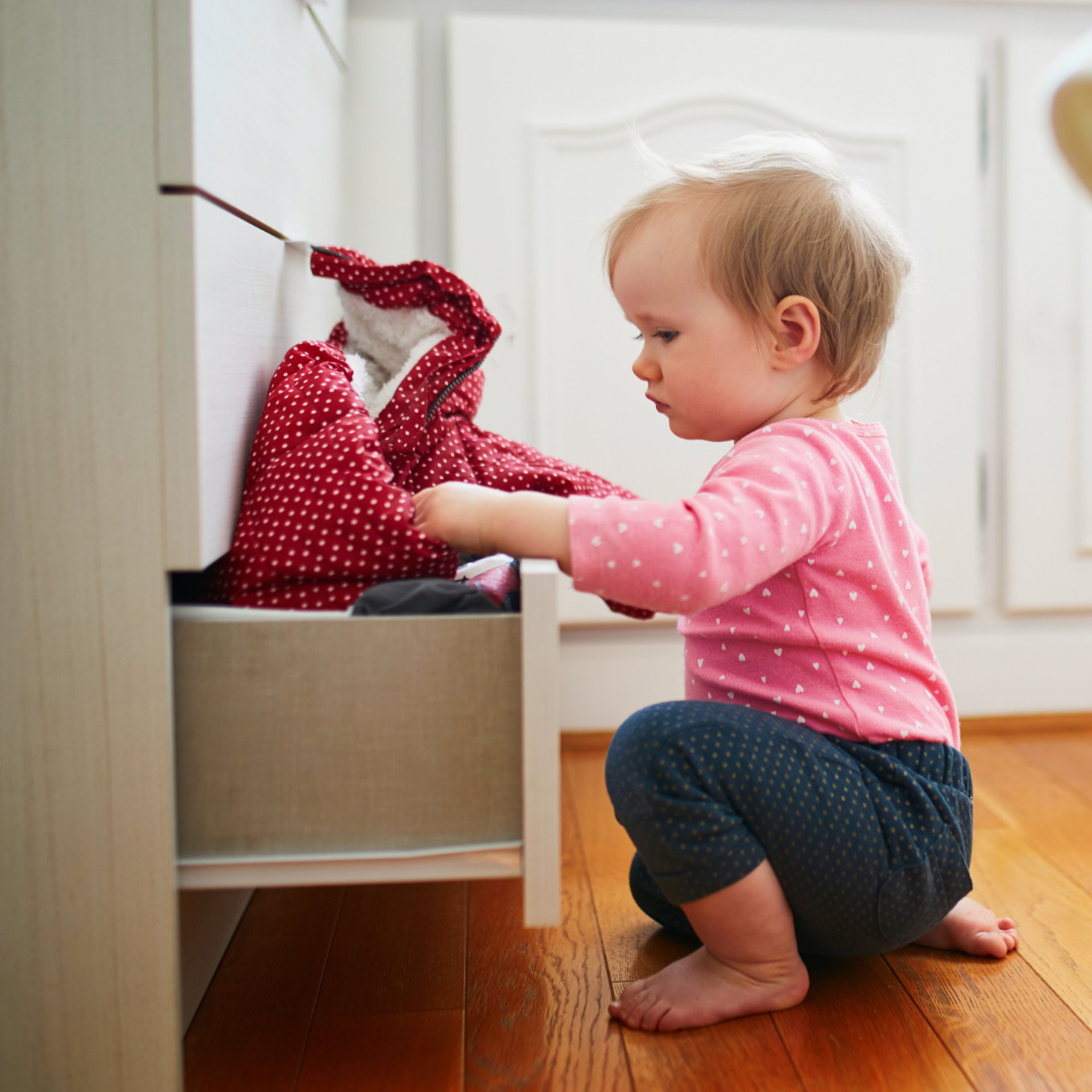 baby rummaging through kitchen drawer