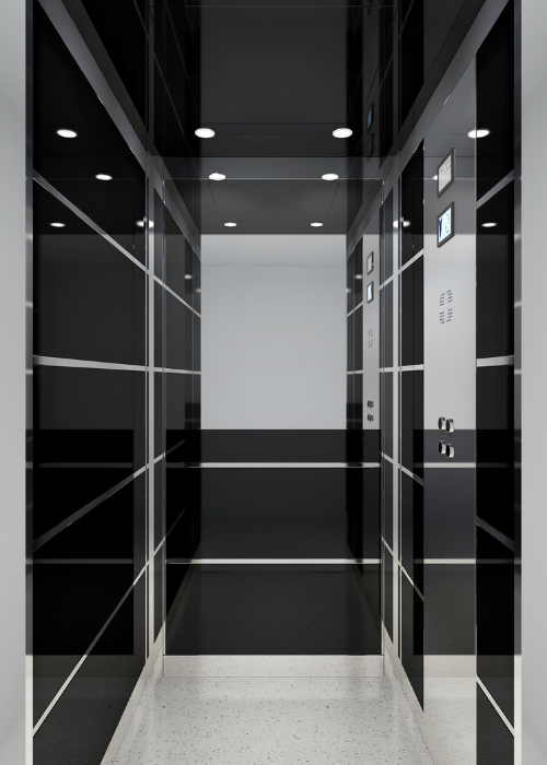 A sleek, modern elevator interior with shiny black walls featuring horizontal lines and bright ceiling lights. There is a control panel on one side with buttons and a digital display, reflecting a contemporary and minimalist design. The floor is light-coloured, contrasting with the dark walls.