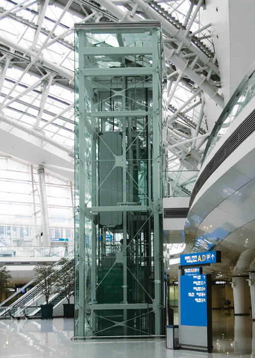 Glass lift in modern airport terminal