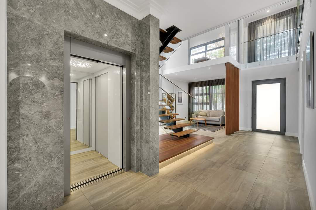 Modern home interior with elevator and staircase.