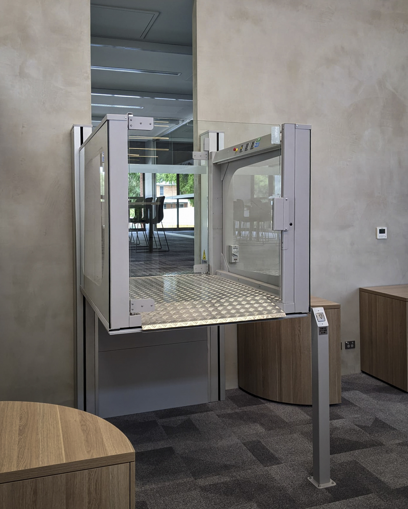Modern indoor wheelchair lift with open platform.
