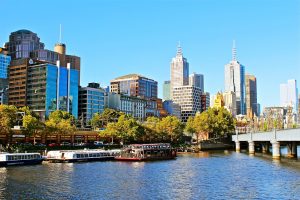 Melbourne city skyline with Yarra River boats.