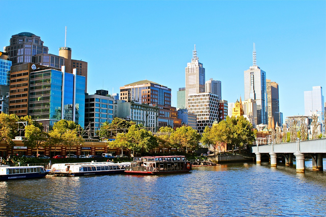Melbourne city skyline with Yarra River boats.