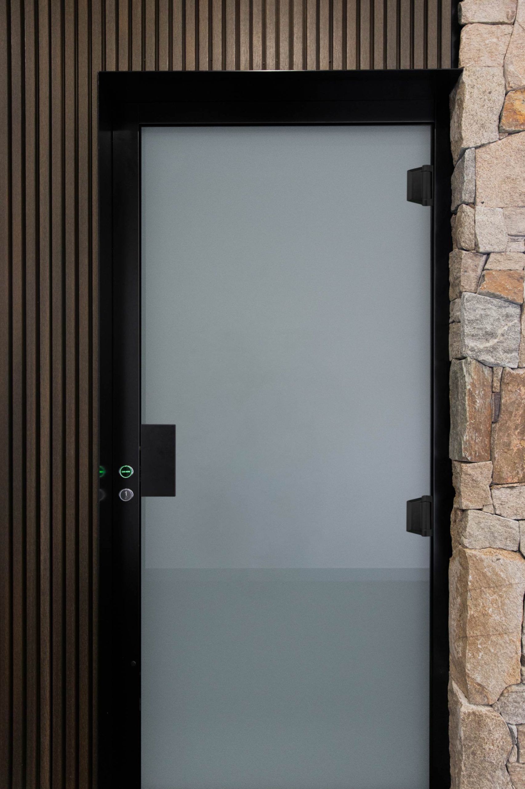 Modern frosted door with stone and wood frame