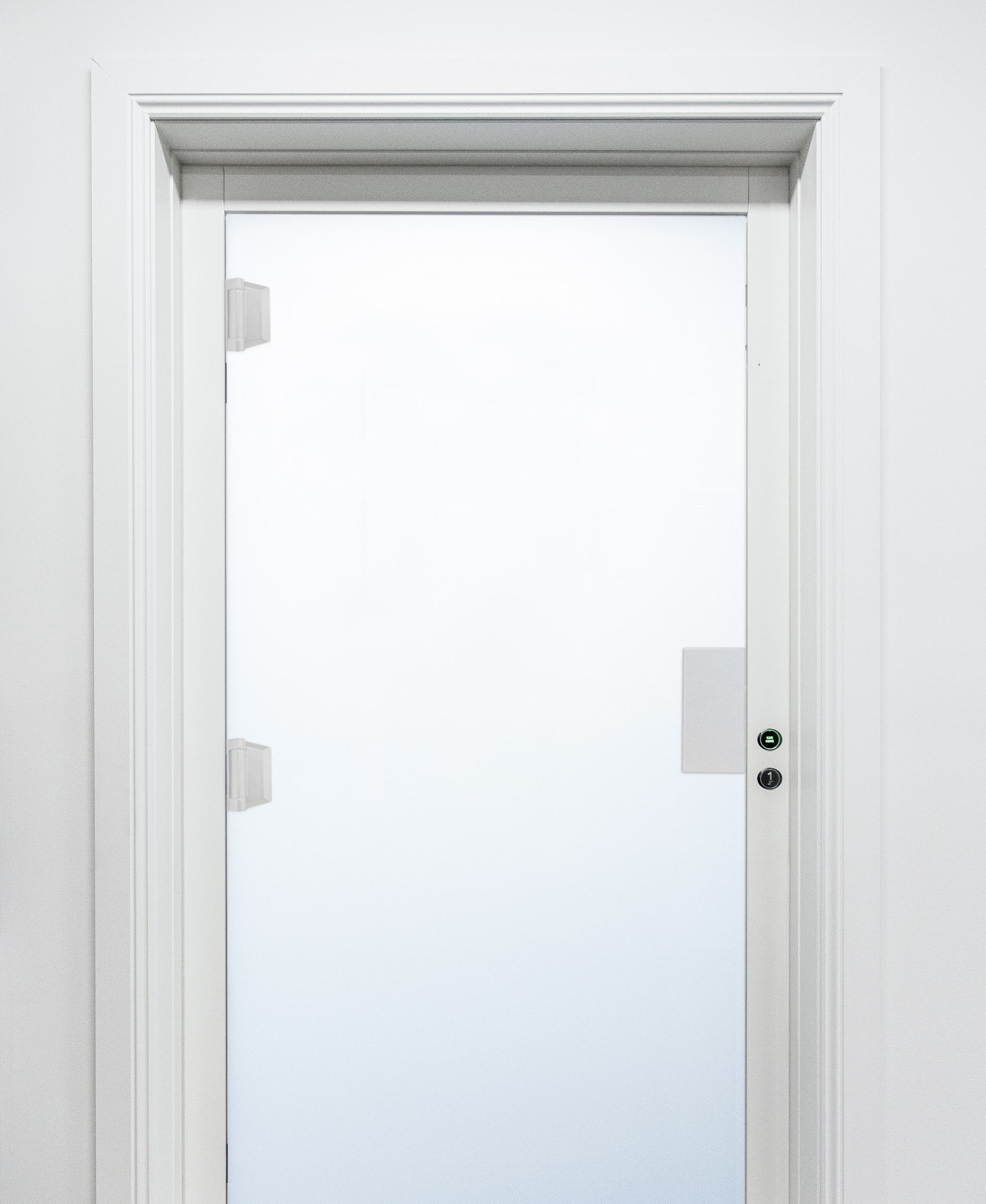 White closed door with frosted glass panel