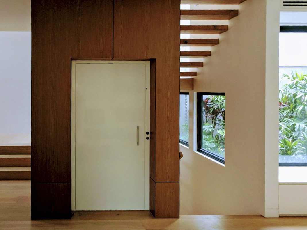 Modern staircase with white door and windows.