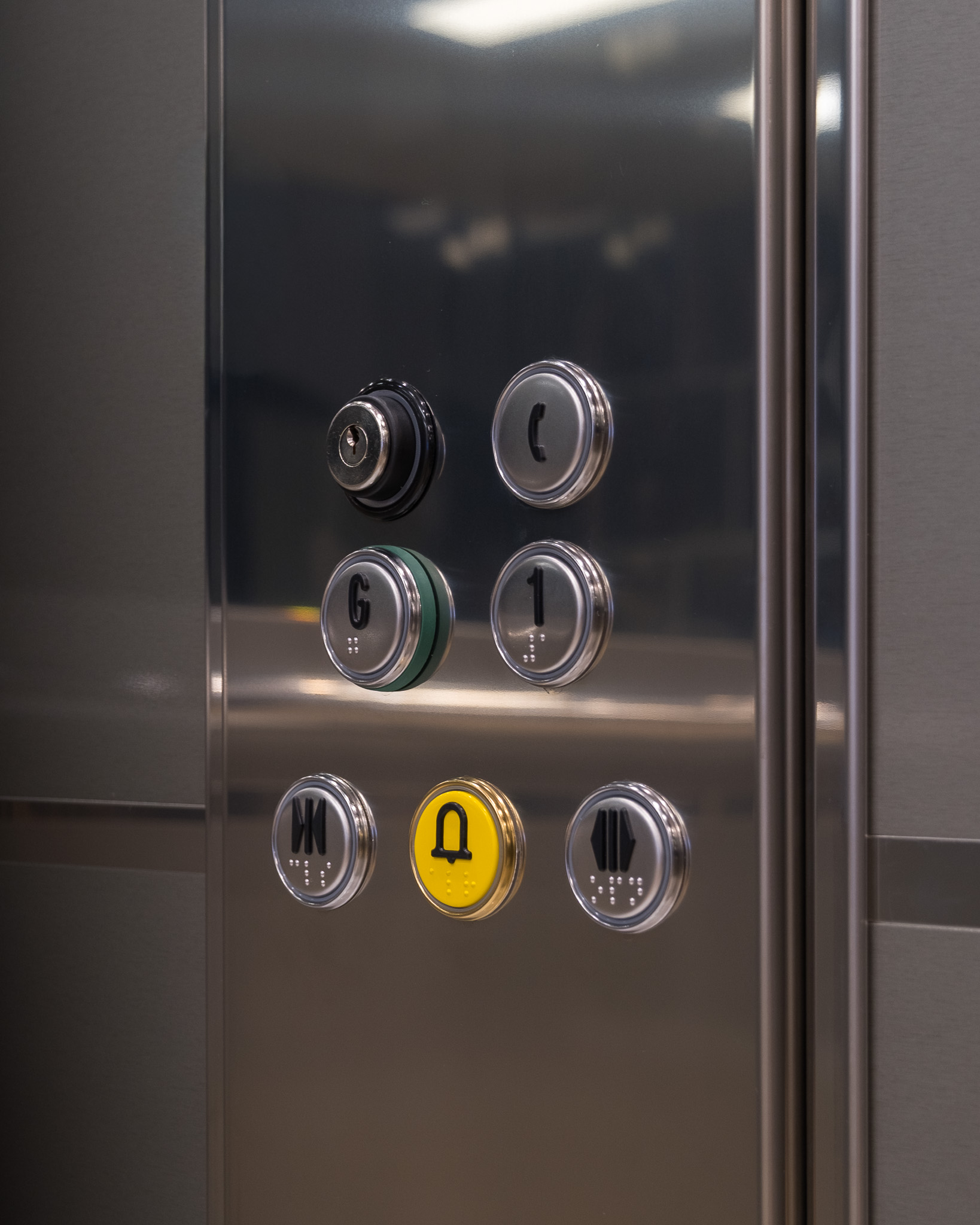 Elevator buttons with Braille and security keyhole.