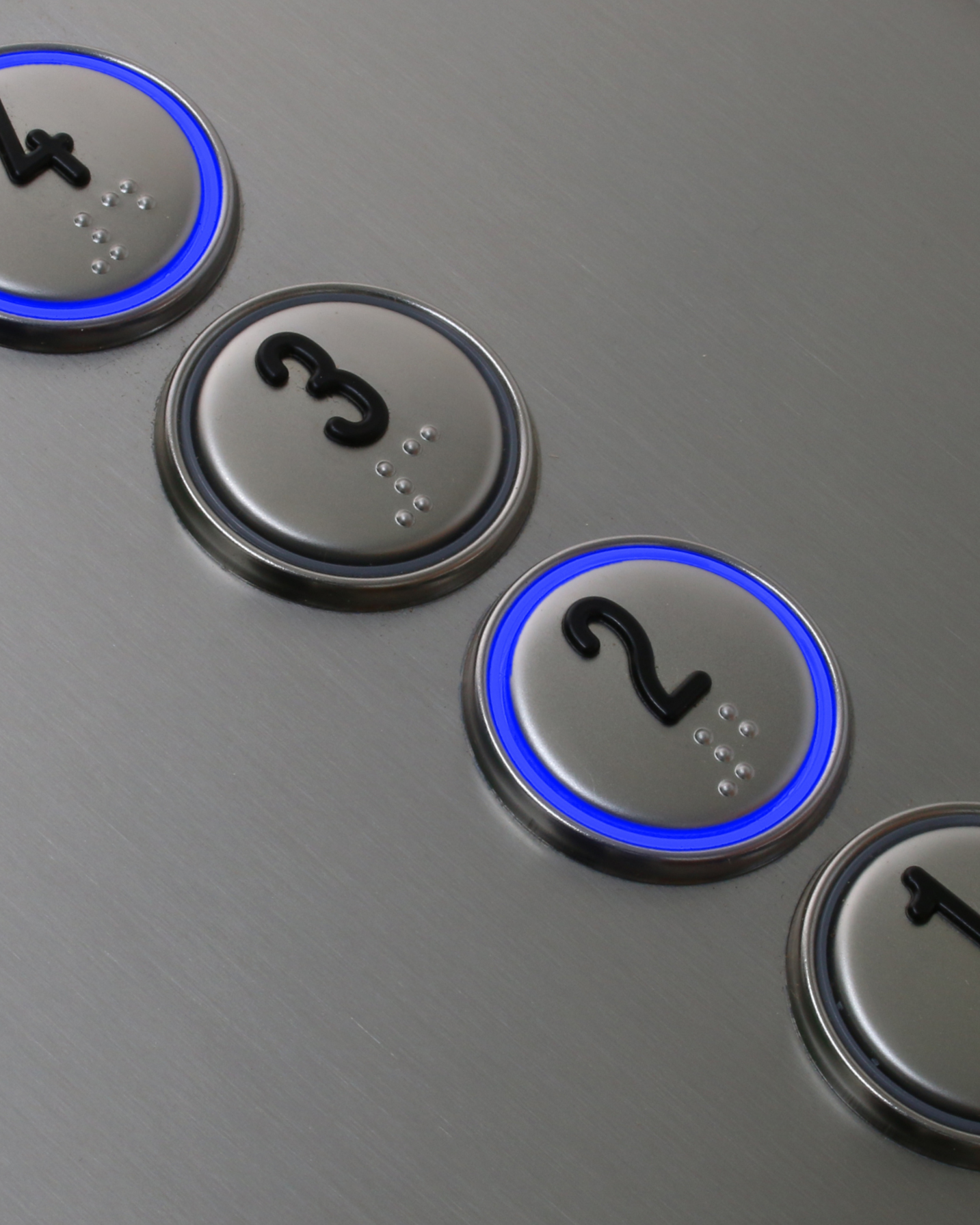 Lift buttons with braille numbers and blue lights.