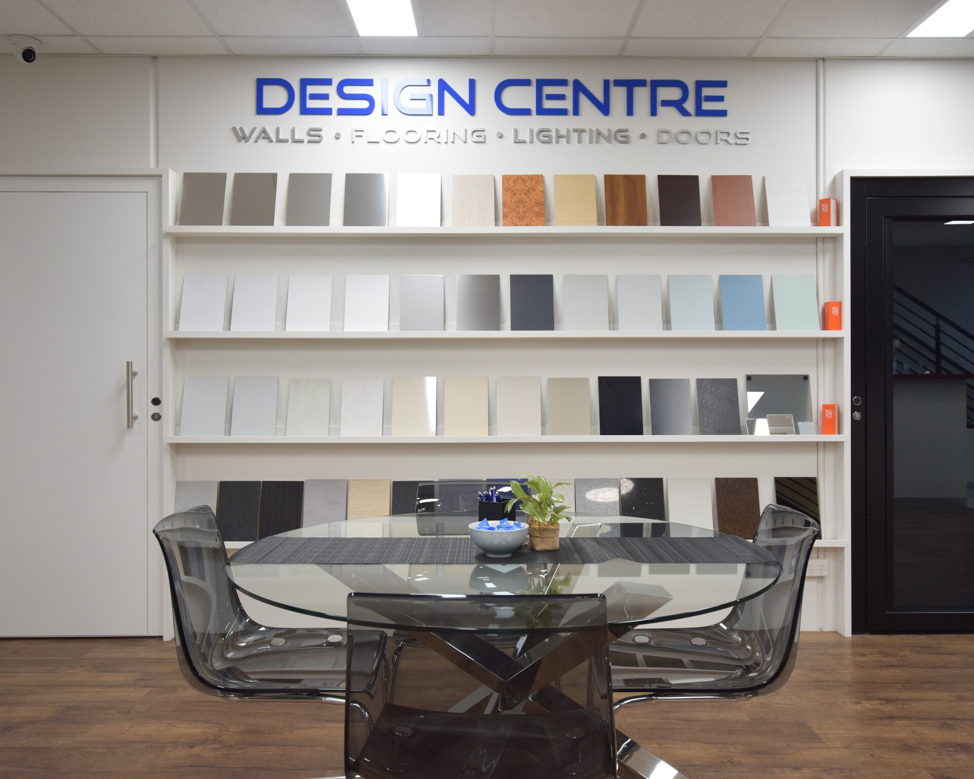 Interior design centre with material samples on shelves.