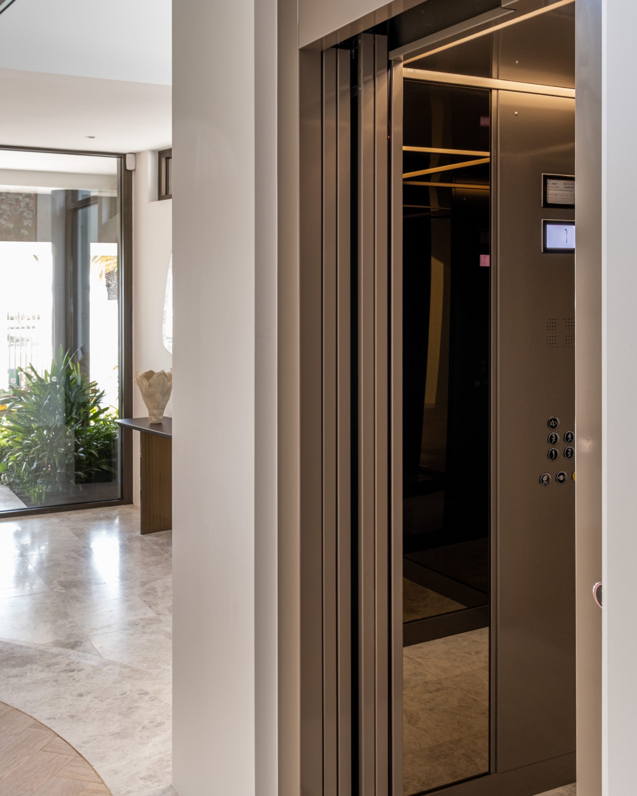 Modern home elevator with open doors.