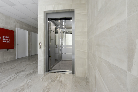Commercial lift1 Empty modern commercial elevator in marble hallway